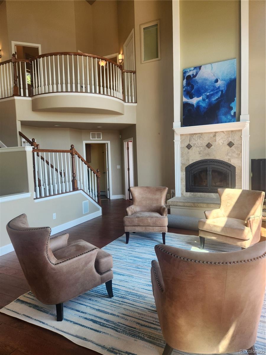 570 Upper Vista Road Manitou Springs, CO 80829 - Photo 8 of 36 a living room with furniture a fireplace and a rug