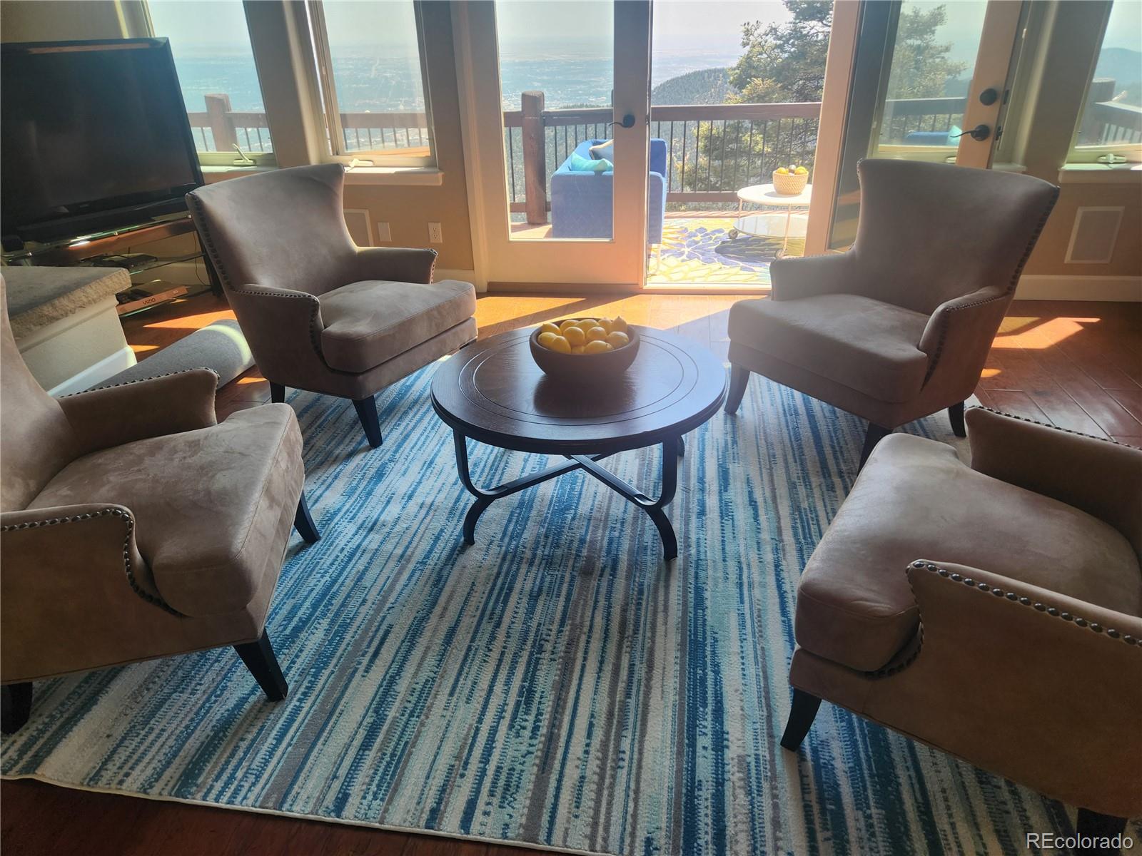570 Upper Vista Road Manitou Springs, CO 80829 - Photo 9 of 36 a balcony with furniture and a potted plant