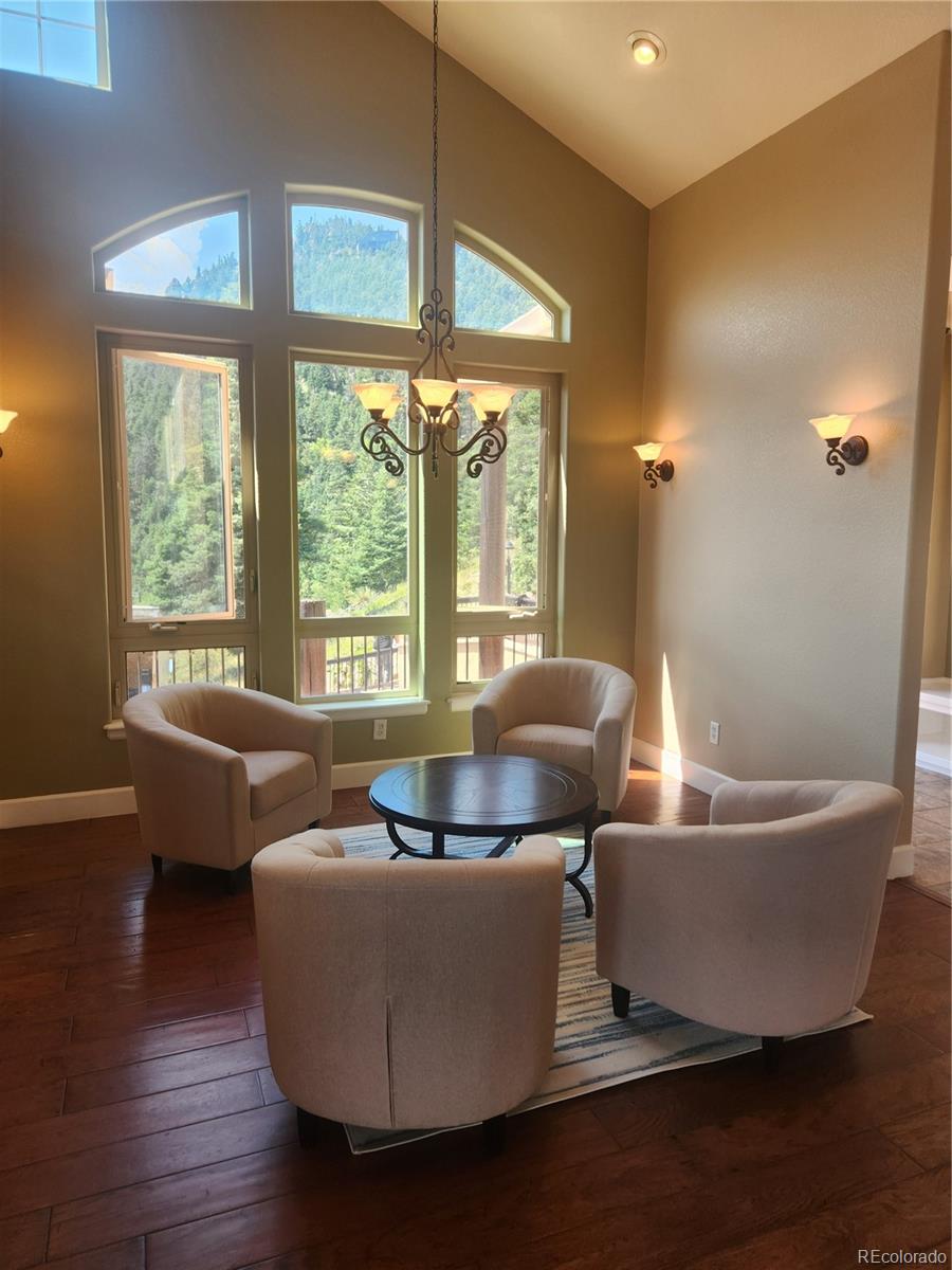 570 Upper Vista Road Manitou Springs, CO 80829 - Photo 10 of 36 a living room with furniture and a large window