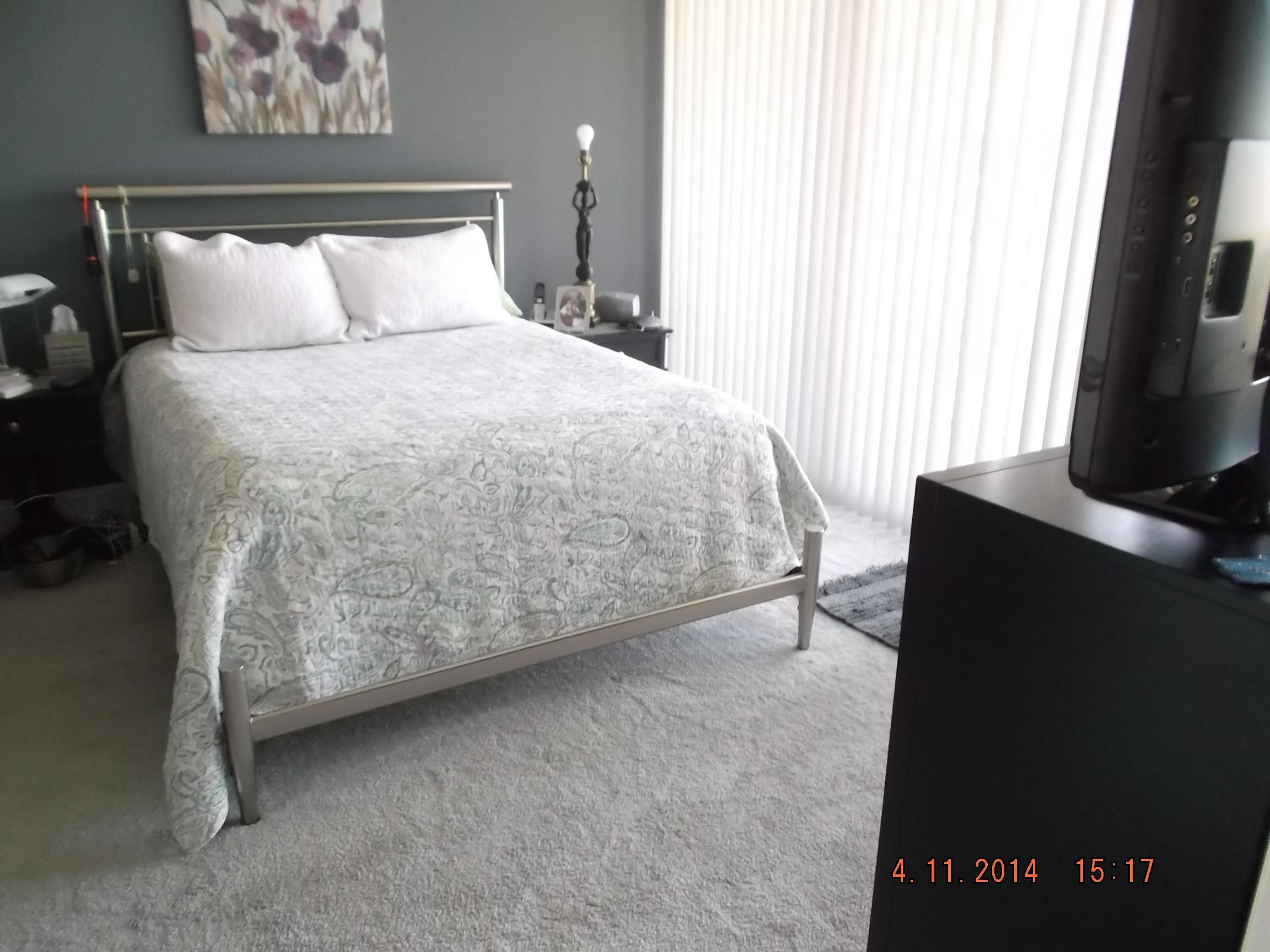 6133 Balboa Circle, Unit 405 Boca Raton, FL 33433 - Photo 15 of 36 a bed sitting in a bedroom next to a window with a tv