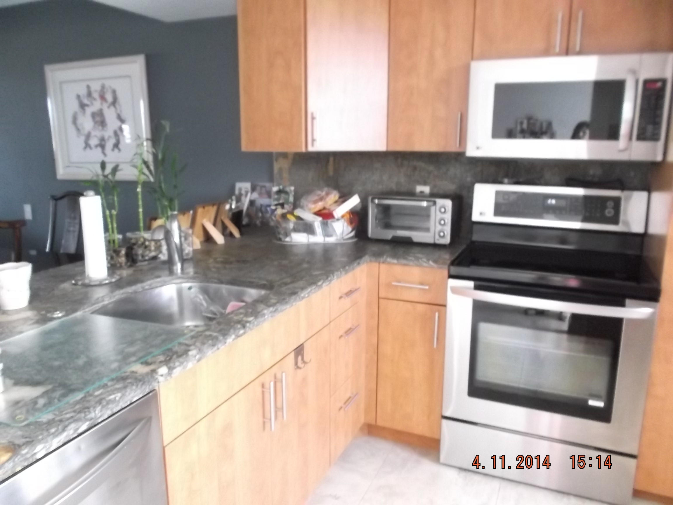 6133 Balboa Circle, Unit 405 Boca Raton, FL 33433 - Photo 2 of 36 a kitchen with a stove and a microwave