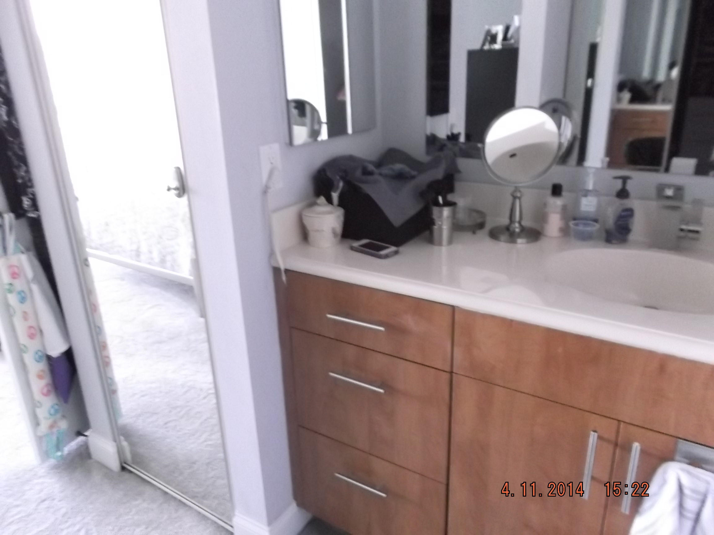 6133 Balboa Circle, Unit 405 Boca Raton, FL 33433 - Photo 21 of 36 a bathroom with a sink and a mirror