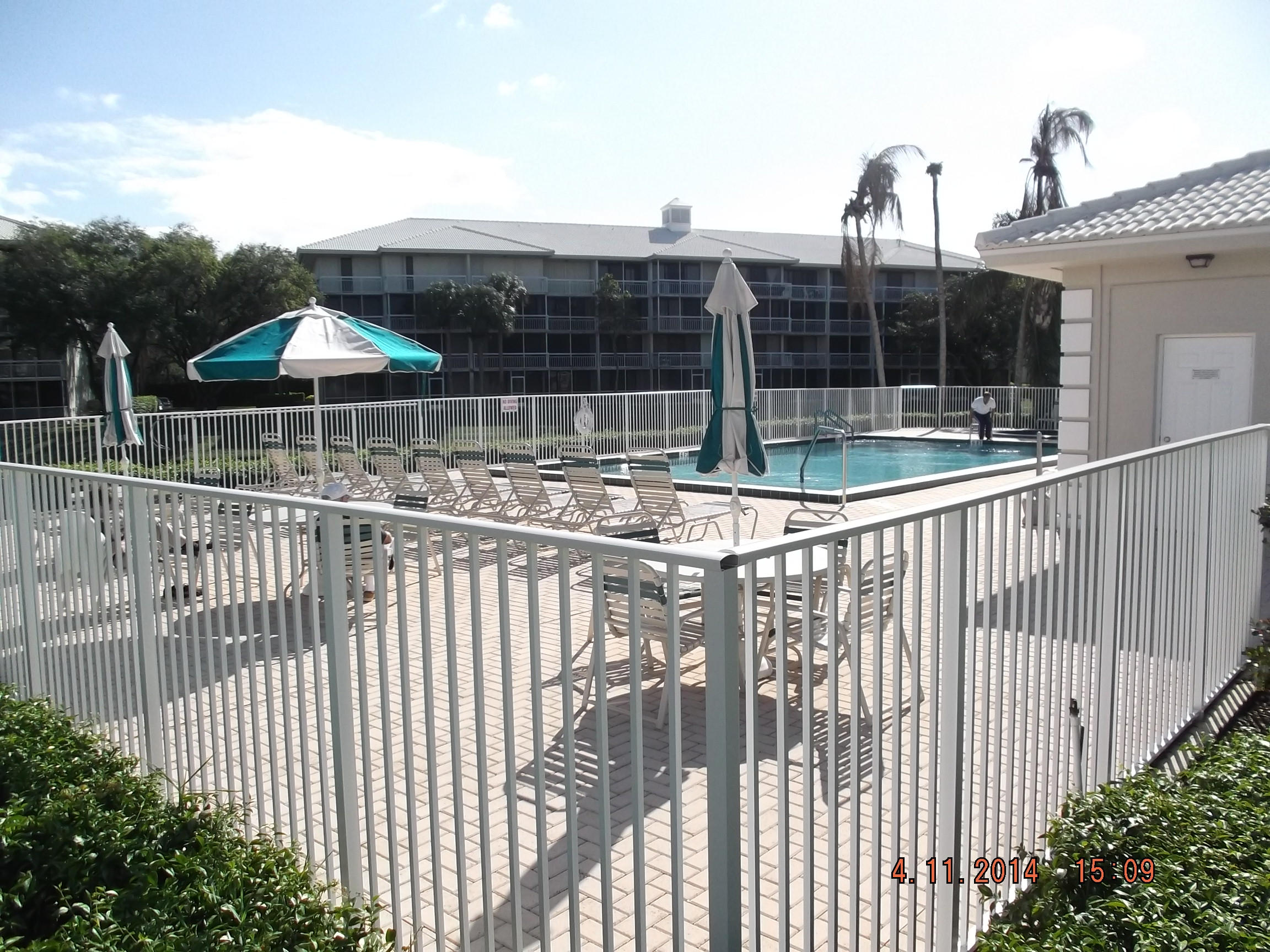 6133 Balboa Circle, Unit 405 Boca Raton, FL 33433 - Photo 34 of 36 a view of a balcony with a floor to ceiling window and wooden fence
