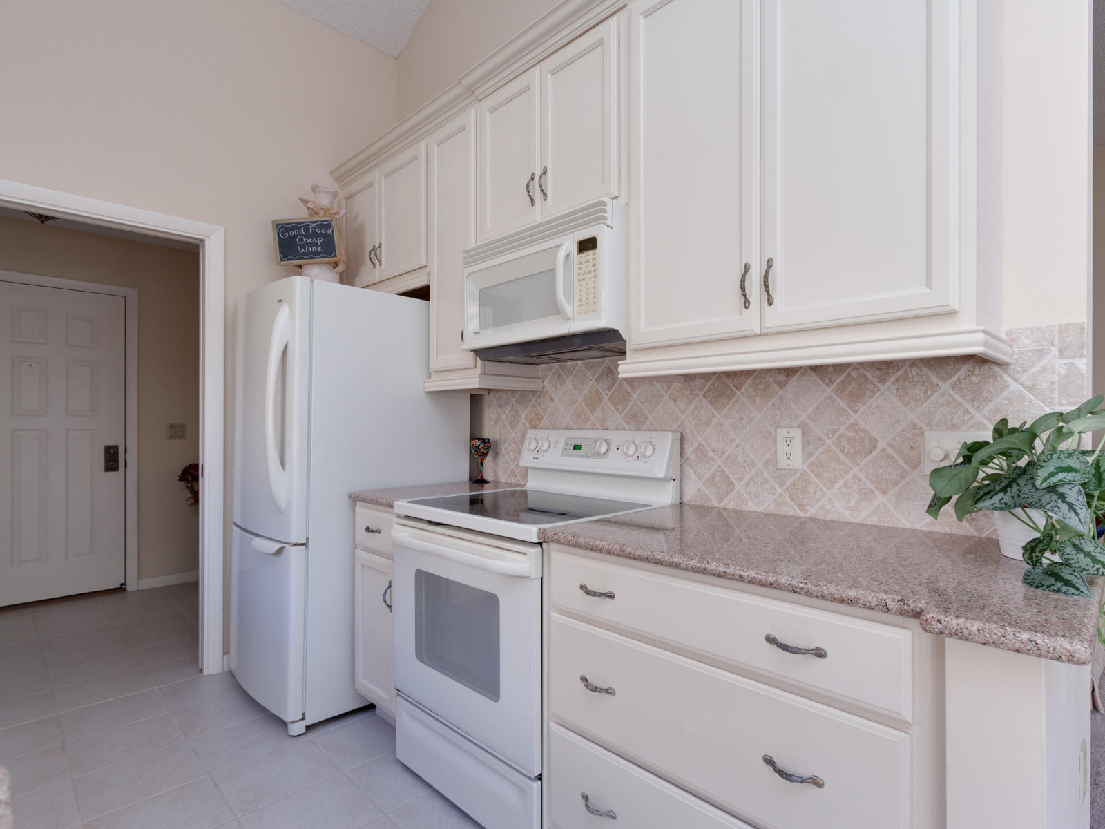 186 Ridge Road Jupiter, FL 33477 - Photo 12 of 44 a kitchen with stainless steel appliances white cabinets and a refrigerator