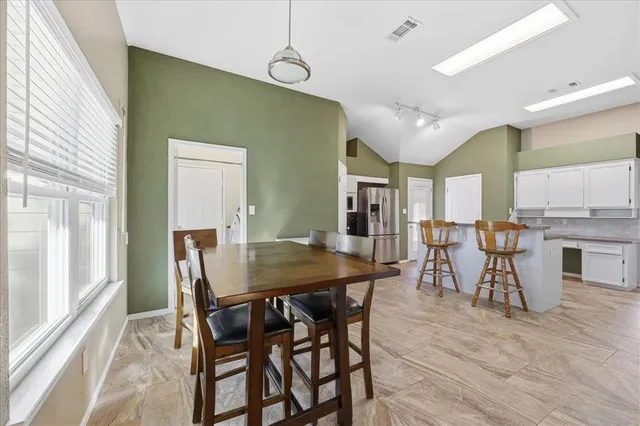 a kitchen with stainless steel appliances granite countertop a sink and a refrigerator