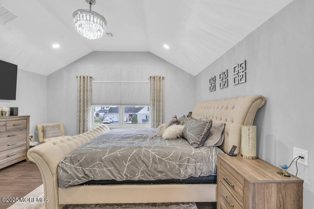 14 Starlight Road Howell, NJ 07731 - Photo 29 of 71 a bedroom with a bed and a chandelier