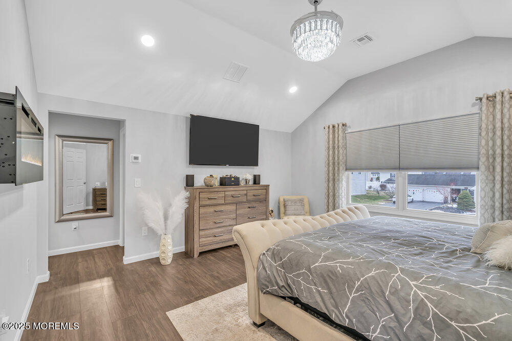 14 Starlight Road Howell, NJ 07731 - Photo 30 of 71 a bedroom with a bed and a flat screen tv