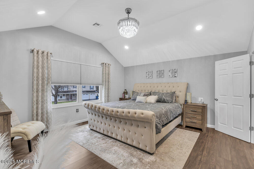 14 Starlight Road Howell, NJ 07731 - Photo 31 of 71 a bedroom with a bed chandelier and a window