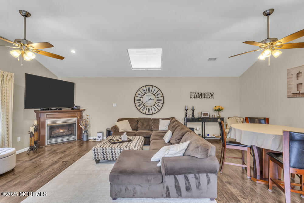 14 Starlight Road Howell, NJ 07731 - Photo 39 of 71 a living room with furniture a flat screen tv and kitchen view