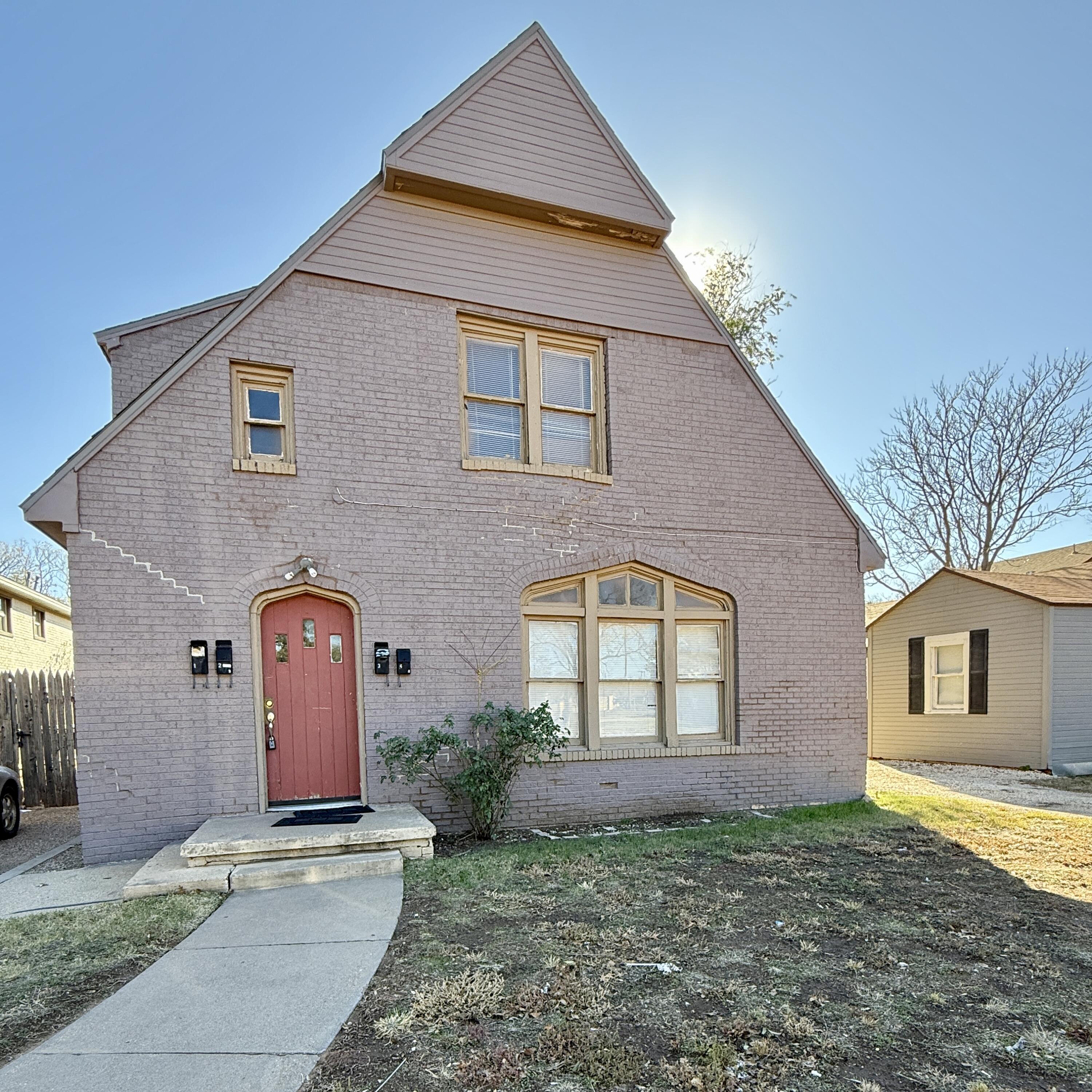 2105 14th Street, Unit 2 Lubbock, TX 79401 - Photo 1 of 15 a view of a house with a yard