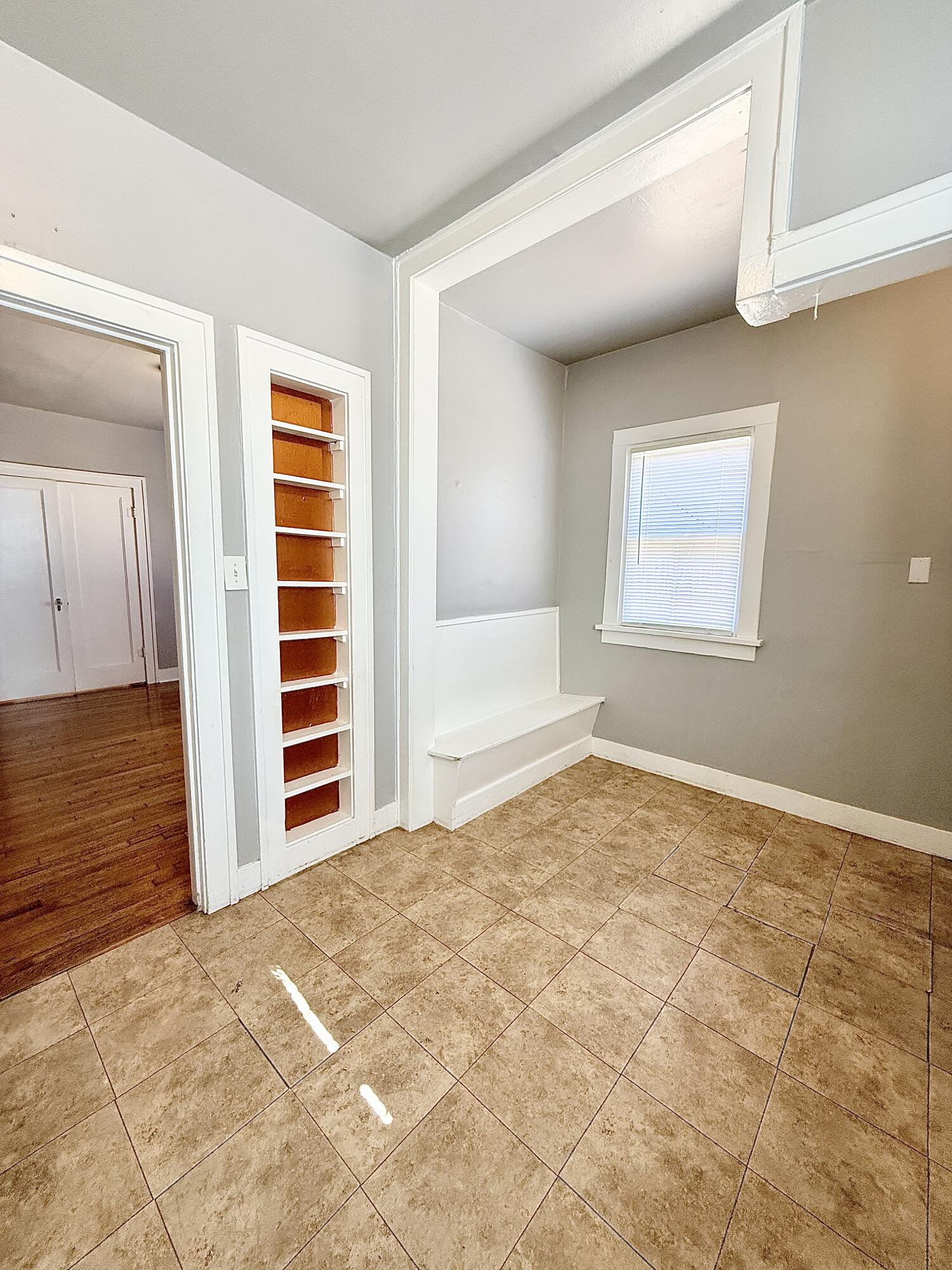 2105 14th Street, Unit 2 Lubbock, TX 79401 - Photo 13 of 15 a view of an empty room with a window