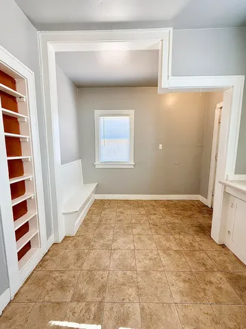 a view of a room with a sink and cabinets