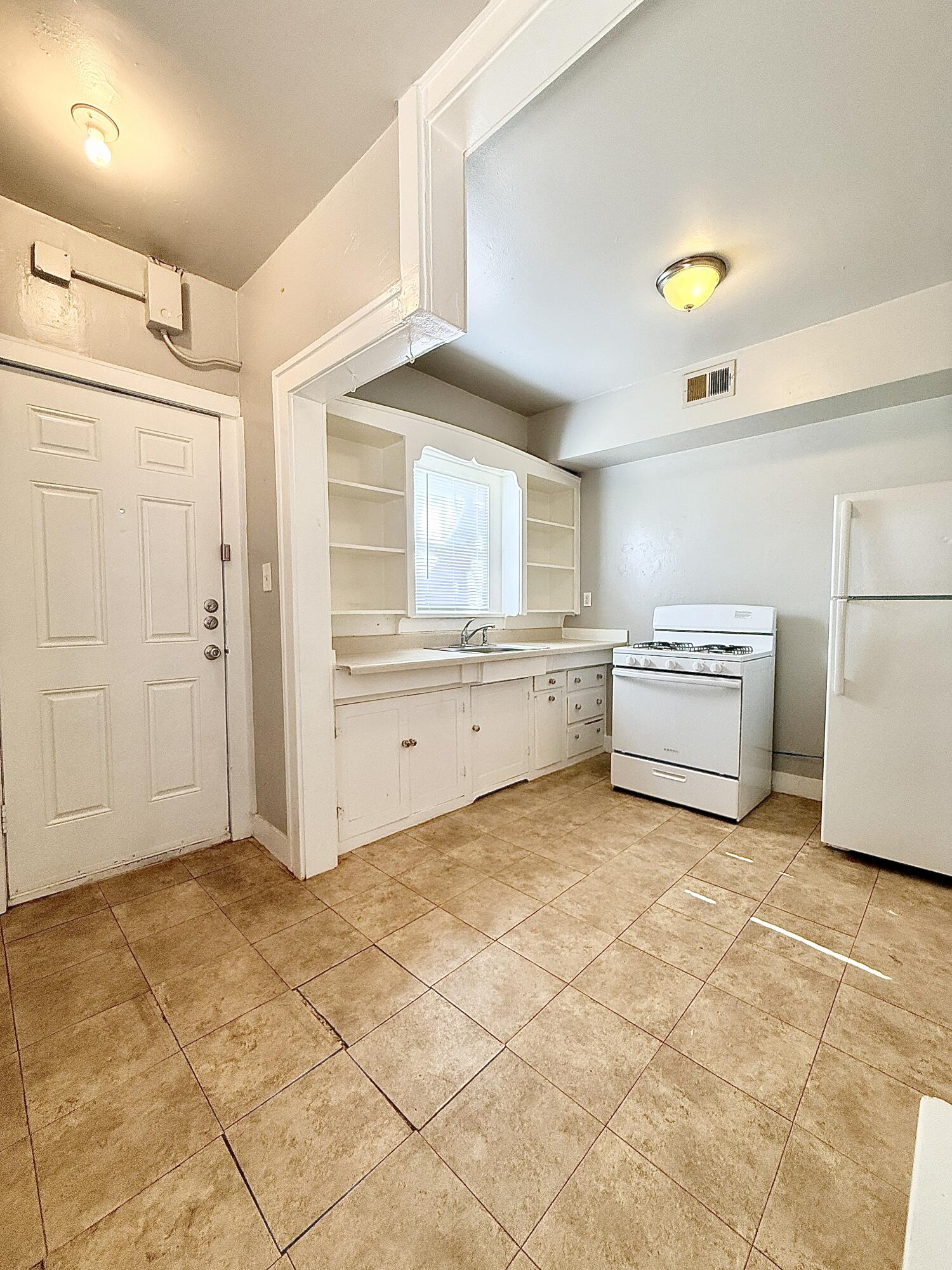 2105 14th Street, Unit 2 Lubbock, TX 79401 - Photo 15 of 15 a view of a kitchen with a sink and a refrigerator