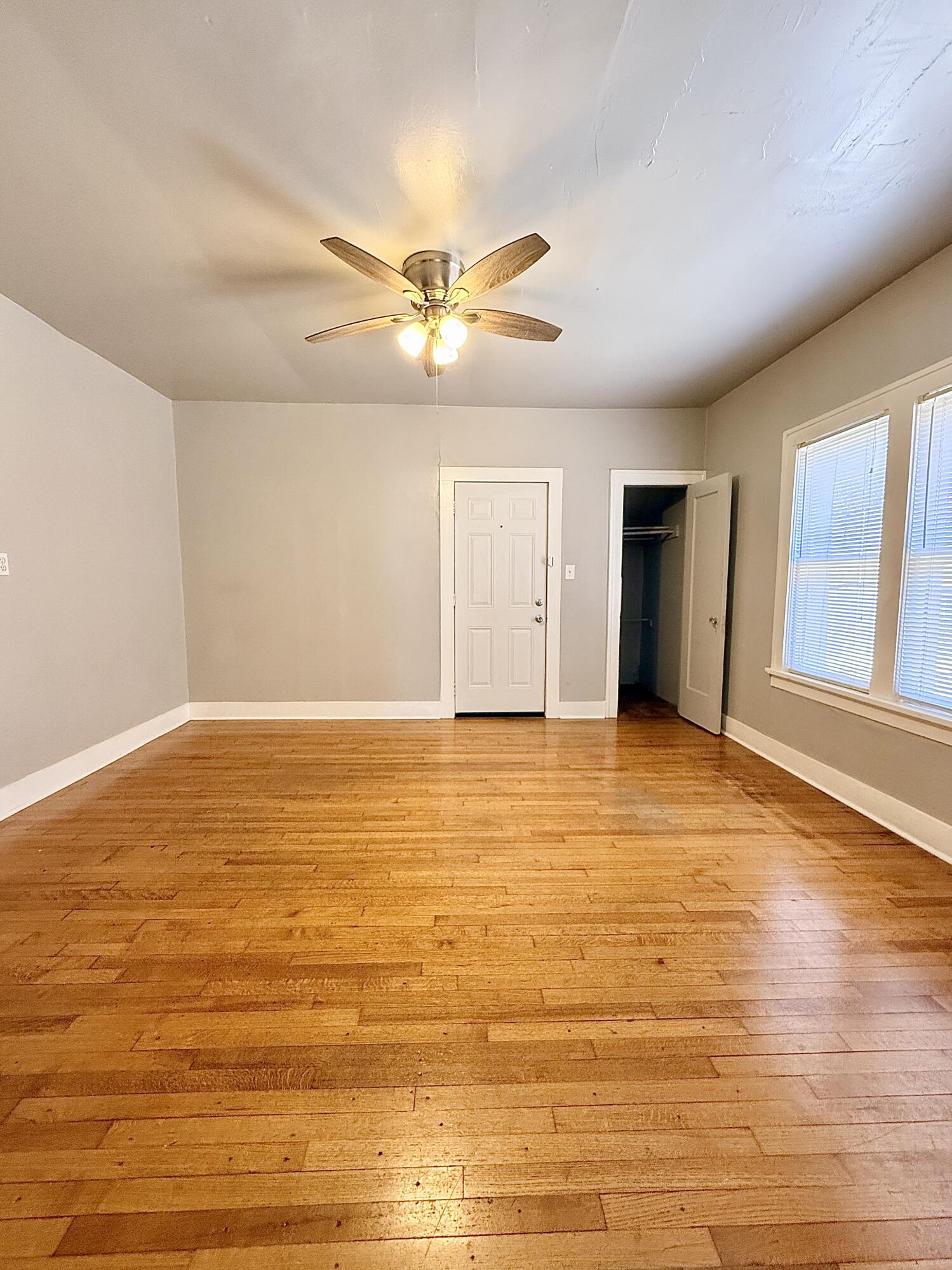 2105 14th Street, Unit 2 Lubbock, TX 79401 - Photo 3 of 15 a view of an empty room with window and a ceiling fan