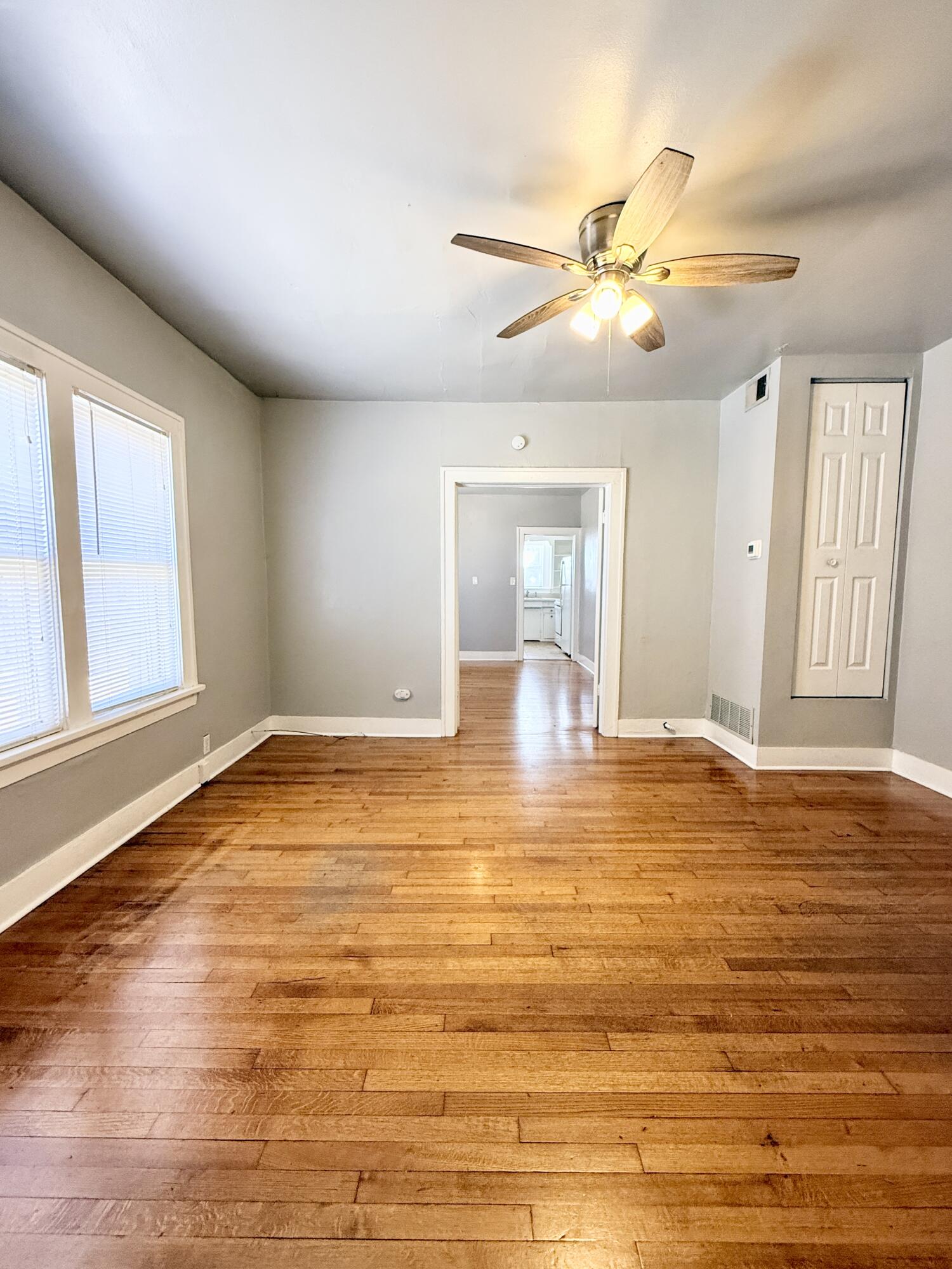 2105 14th Street, Unit 2 Lubbock, TX 79401 - Photo 4 of 15 a view of empty room with wooden floor and fan
