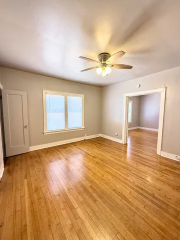 a view of an empty room and wooden floor