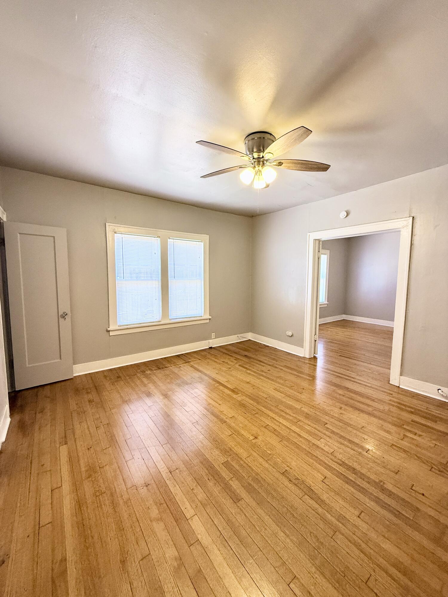 2105 14th Street, Unit 2 Lubbock, TX 79401 - Photo 5 of 15 a view of an empty room and wooden floor