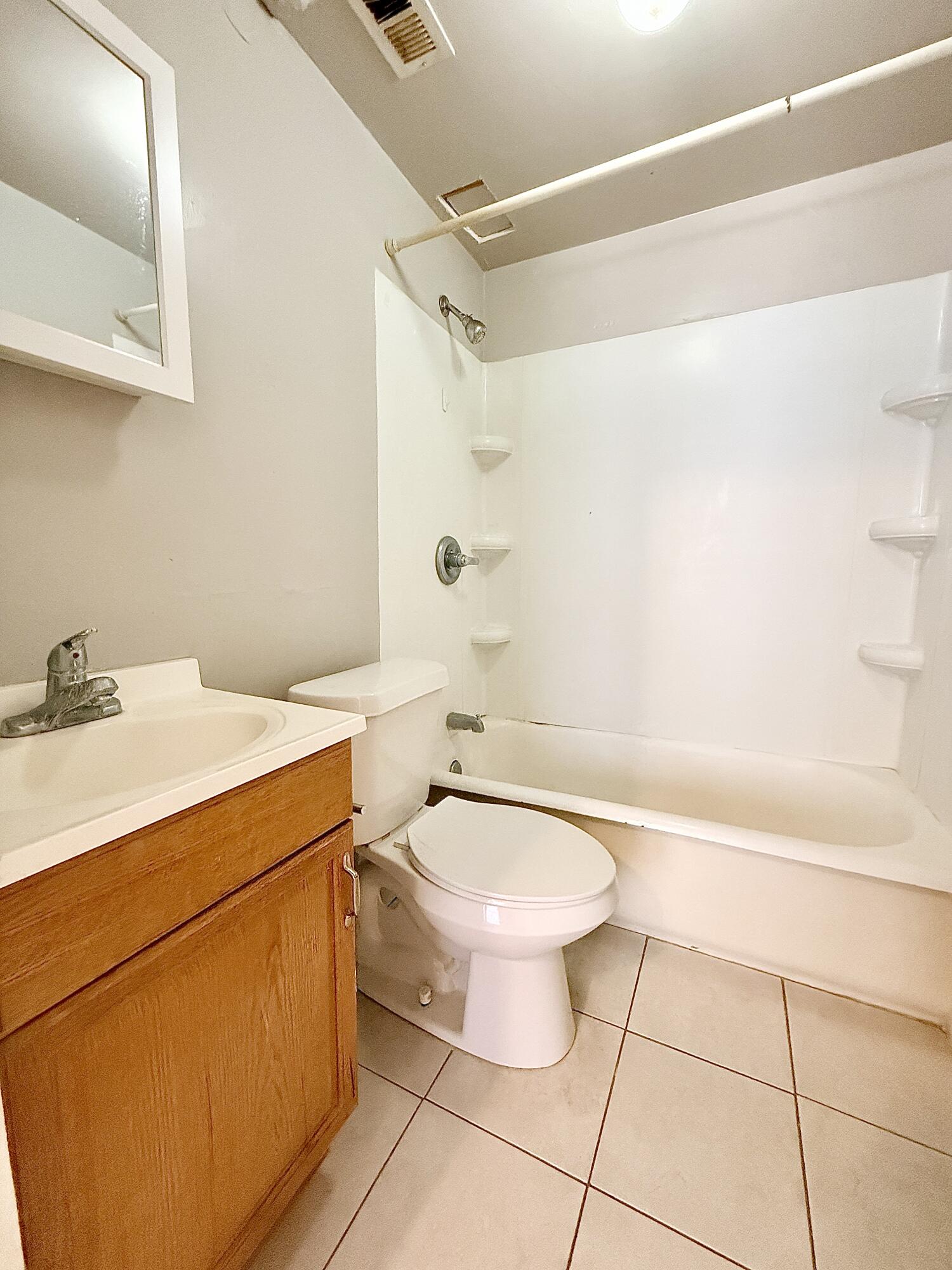 2105 14th Street, Unit 2 Lubbock, TX 79401 - Photo 10 of 15 a bathroom with a sink a toilet and shower