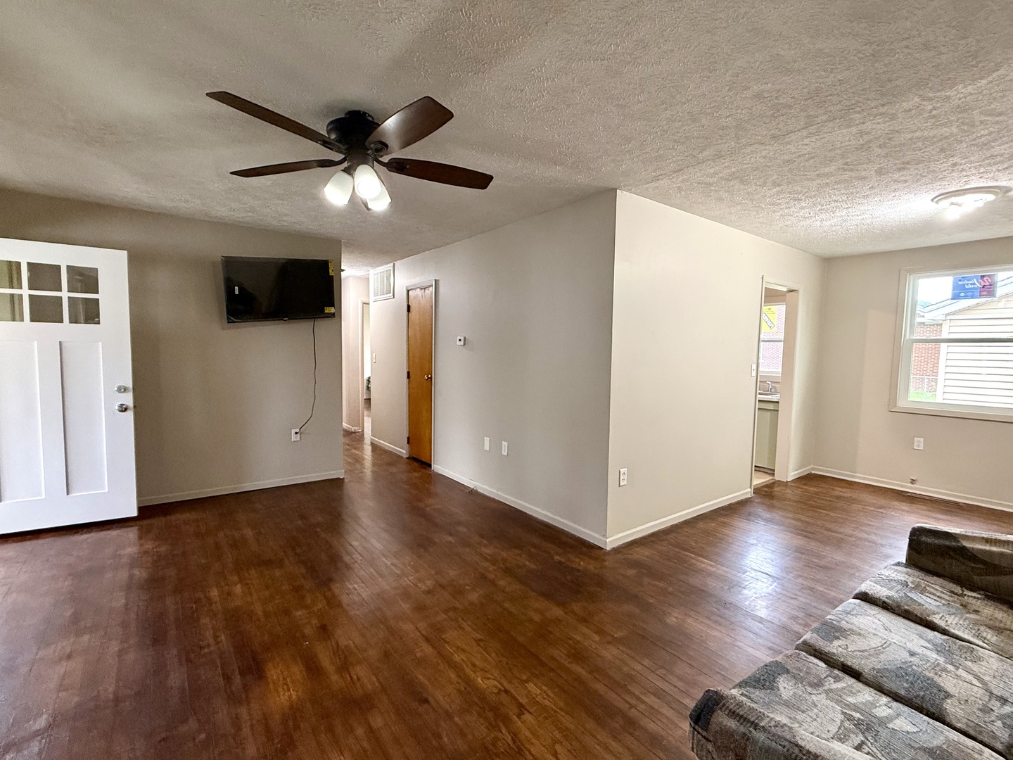 1305 Harper Drive Rantoul, IL 61866 - Photo 3 of 10 a view of an empty room with wooden floor and a window