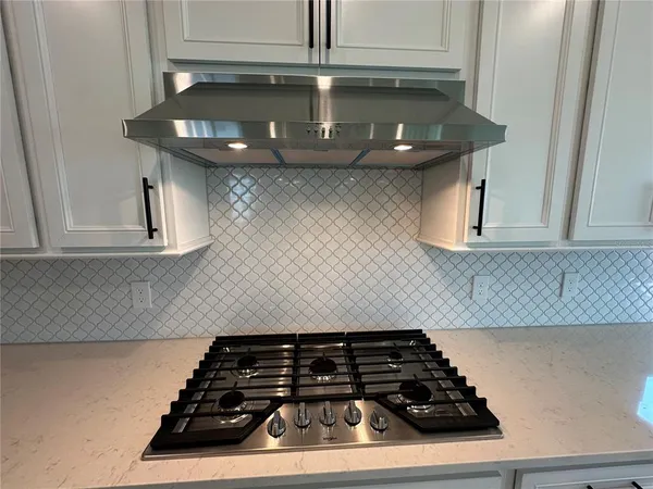 a kitchen with a stove and a cabinet