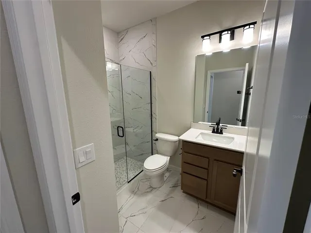 a white toilet sitting next to a bathroom sink