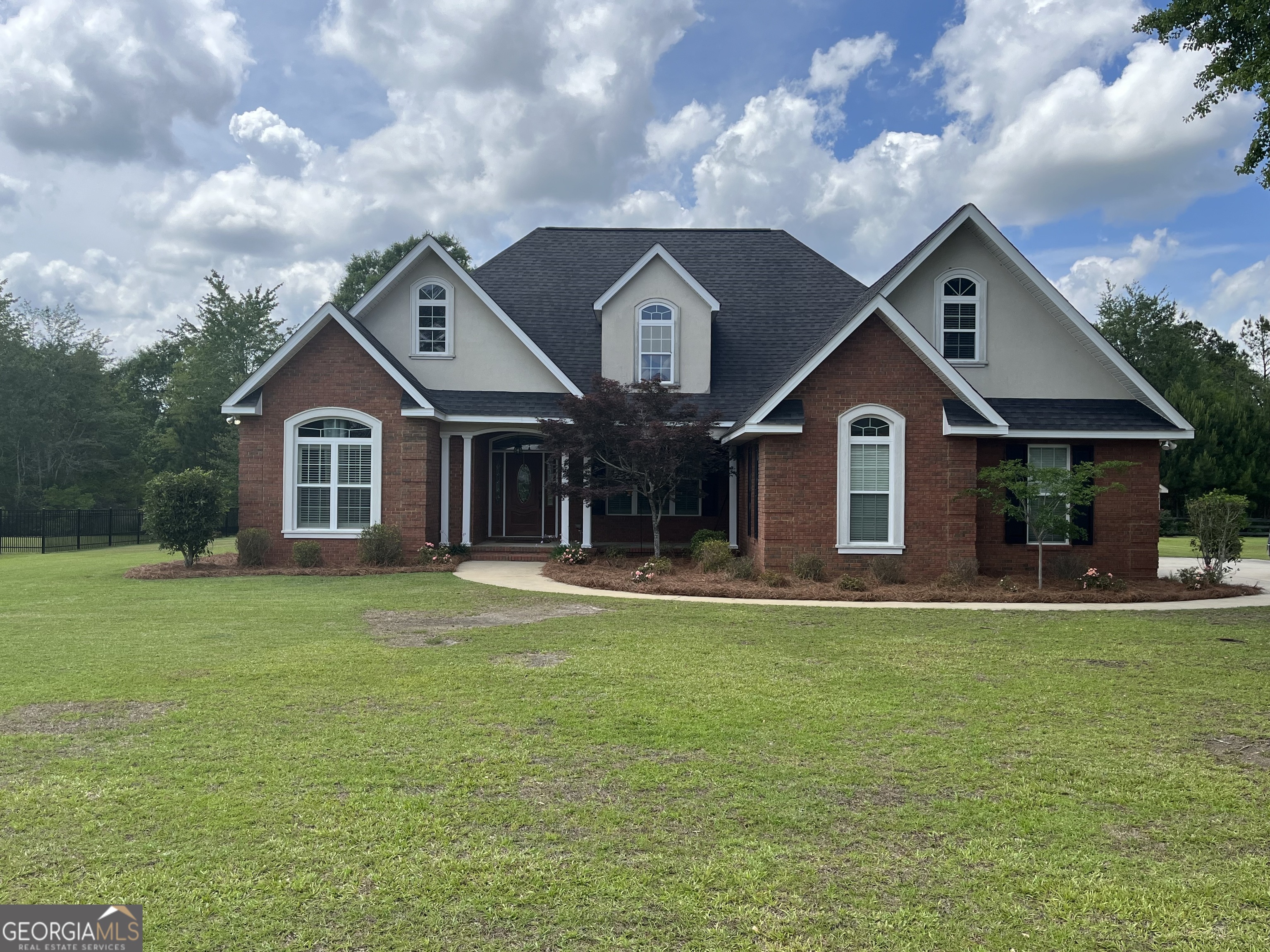 110 Hedge Way Dublin, GA 31021 - Photo 1 of 1 a front view of a house with a garden and plants