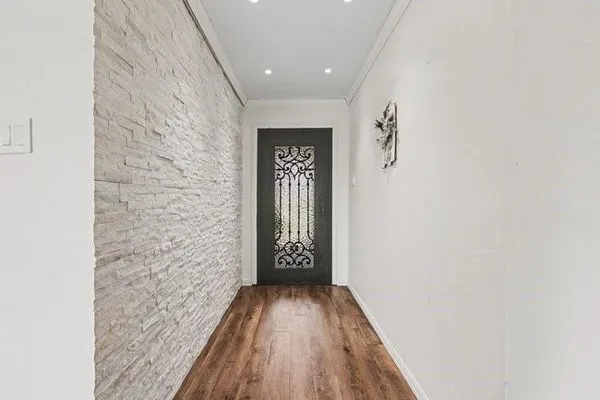 a view of a hallway with wooden floor