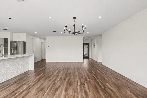 a view of a kitchen with wooden floor and a sink