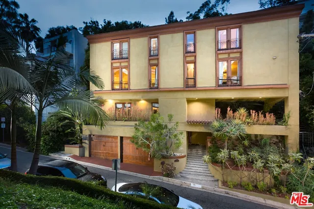 front view of a house with potted plants