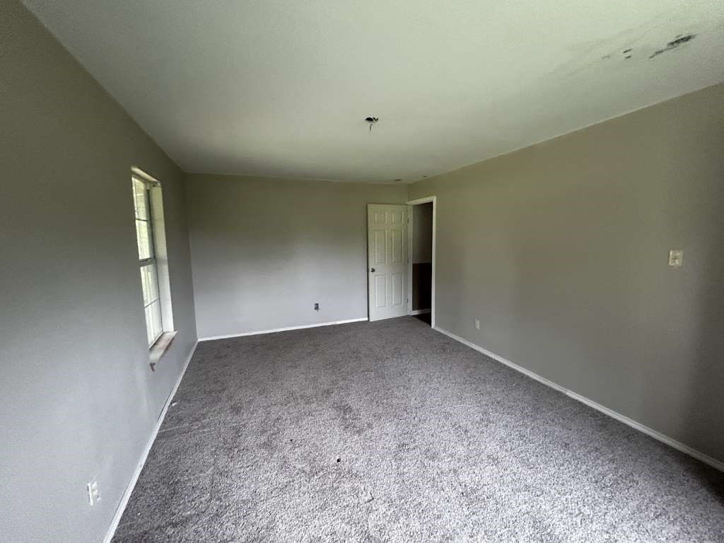 206 Grayson Street Teague, TX 75860 - Photo 7 of 9 a view of an empty room and window