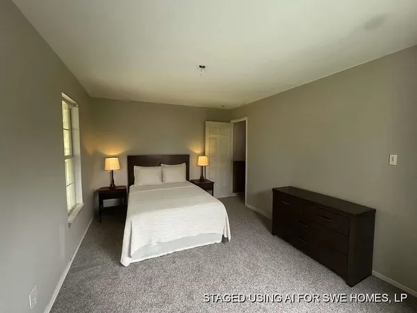 a bedroom with a bed and a night stand