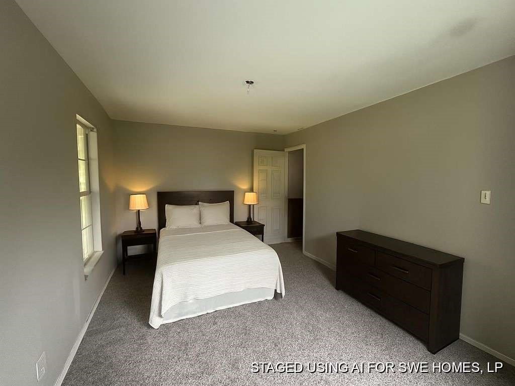 206 Grayson Street Teague, TX 75860 - Photo 8 of 9 a bedroom with a bed and a night stand