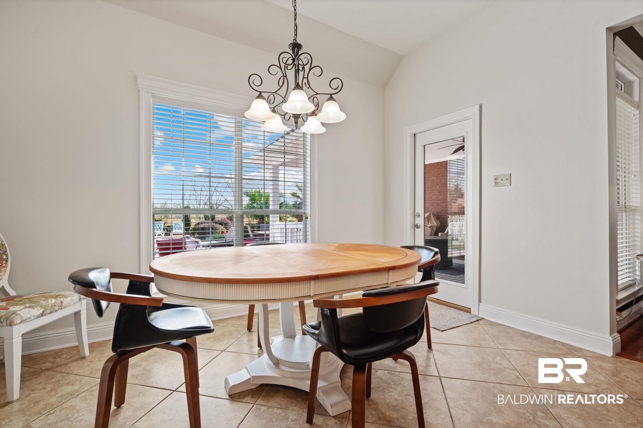 4771 Pecan Ridge East Mobile, AL 36619 - Photo 21 of 48 Dining room with lofted ceiling, plenty of natural light, a chandelier, and light tile patterned flooring