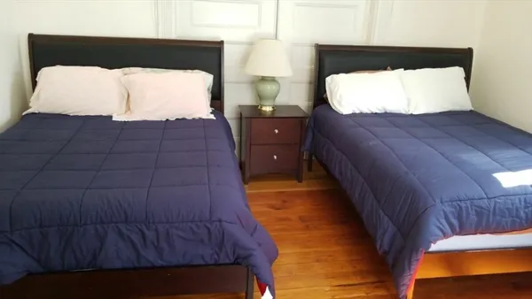 a bedroom with a bed and window
