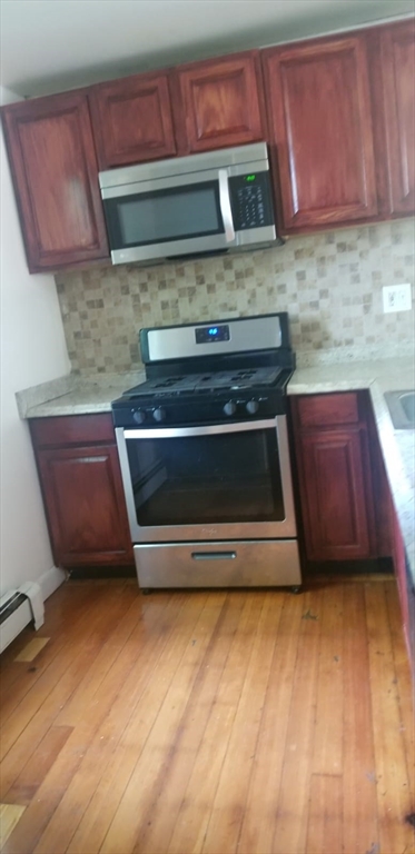 36 Gordon Street Boston, MA 02134 - Photo 7 of 14 a kitchen with granite countertop a stove and a sink