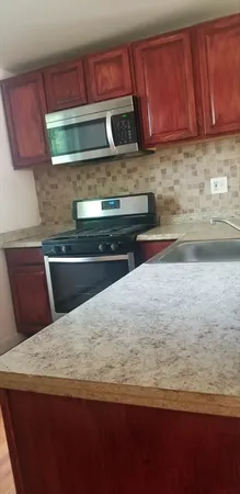 a kitchen with a stove and a microwave