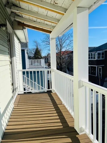 a view of a porch with wooden floor and fence