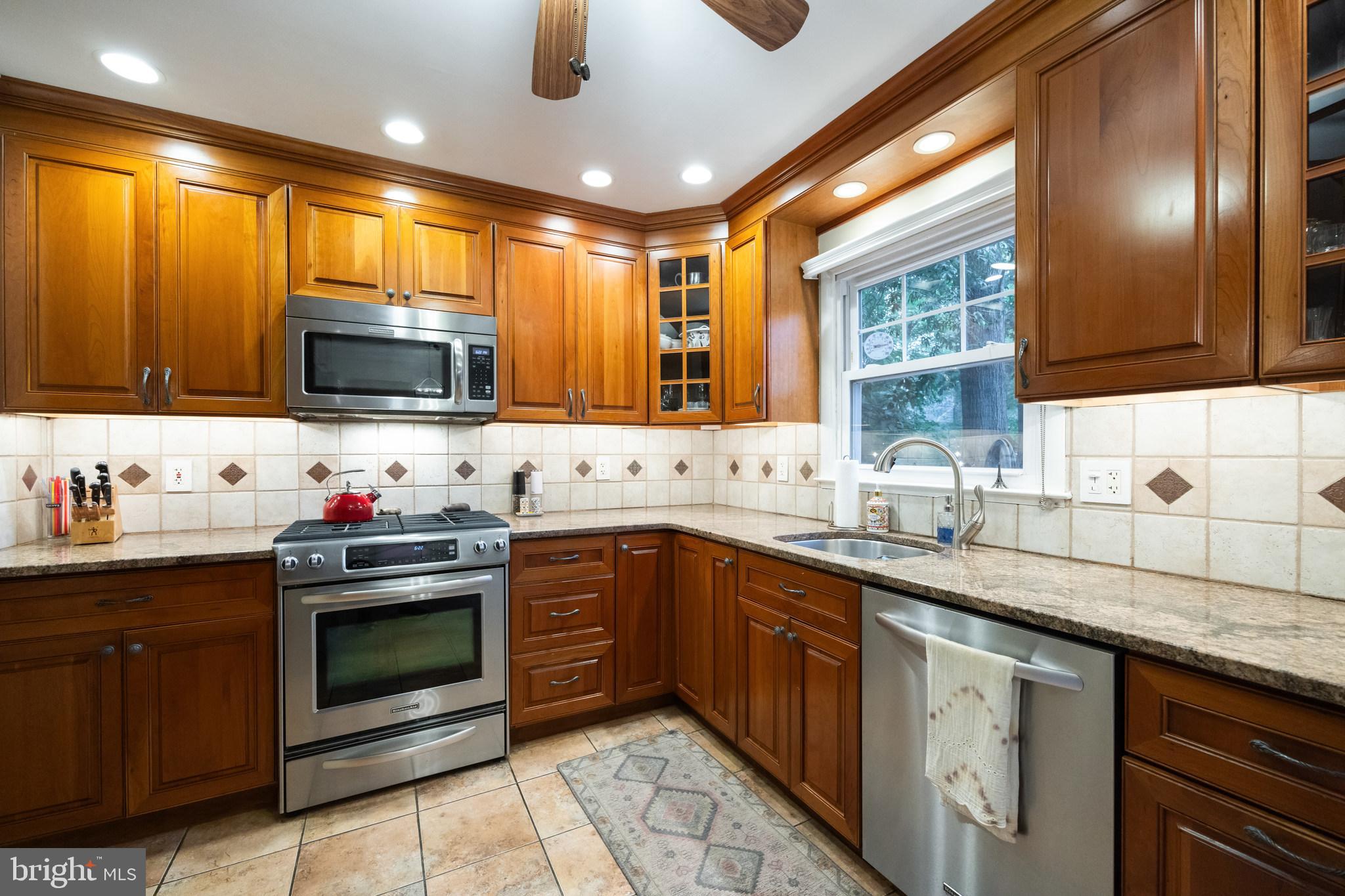 12 Cooper Run Drive Cherry Hill, NJ 08003 - Photo 13 of 50 a kitchen with stainless steel appliances granite countertop a sink and stove top oven