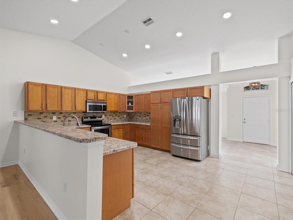 11217 Kangley Lane Spring Hill, FL 34608 - Photo 11 of 43 a kitchen with granite countertop a sink and cabinets