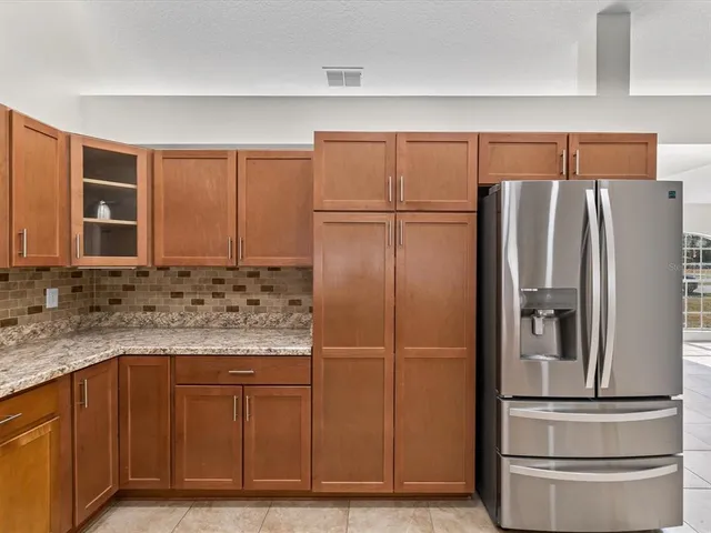 a kitchen with stainless steel appliances granite countertop a refrigerator and a sink
