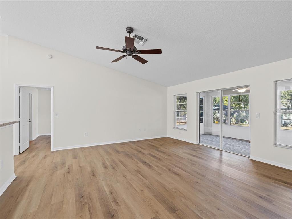 11217 Kangley Lane Spring Hill, FL 34608 - Photo 16 of 43 a view of empty room with wooden floor and fan