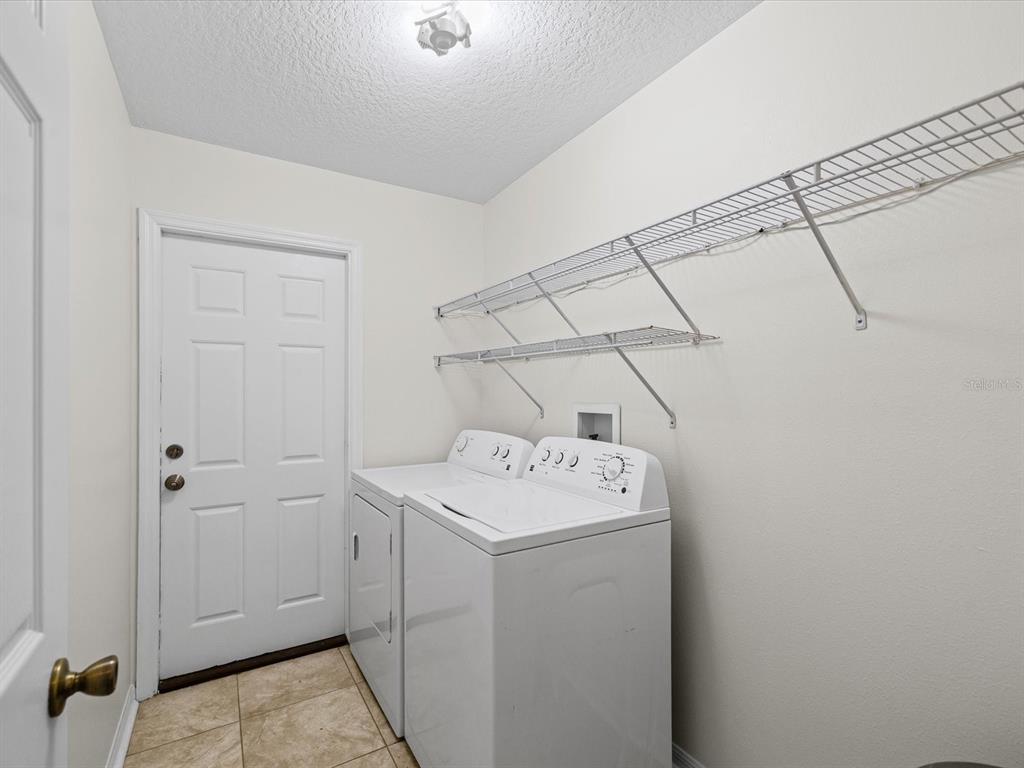 11217 Kangley Lane Spring Hill, FL 34608 - Photo 32 of 43 a utility room with dryer and washer