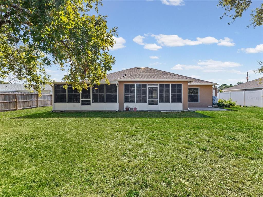 11217 Kangley Lane Spring Hill, FL 34608 - Photo 37 of 43 a view of a house with a backyard