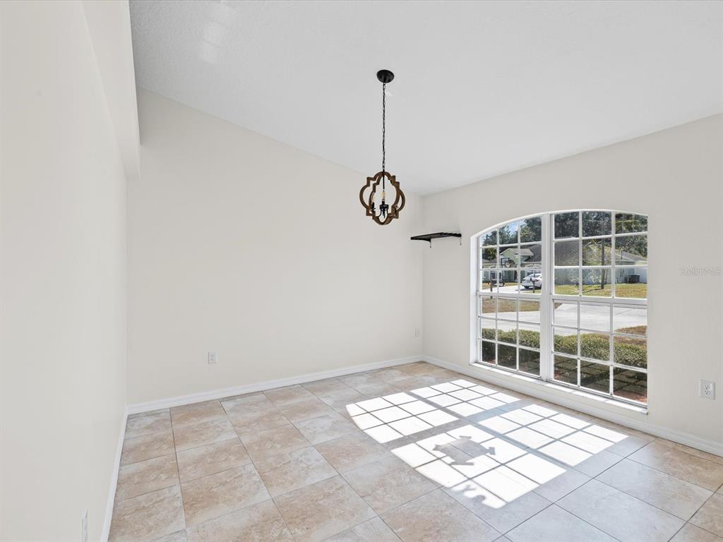 11217 Kangley Lane Spring Hill, FL 34608 - Photo 9 of 43 a view of an empty room with windows