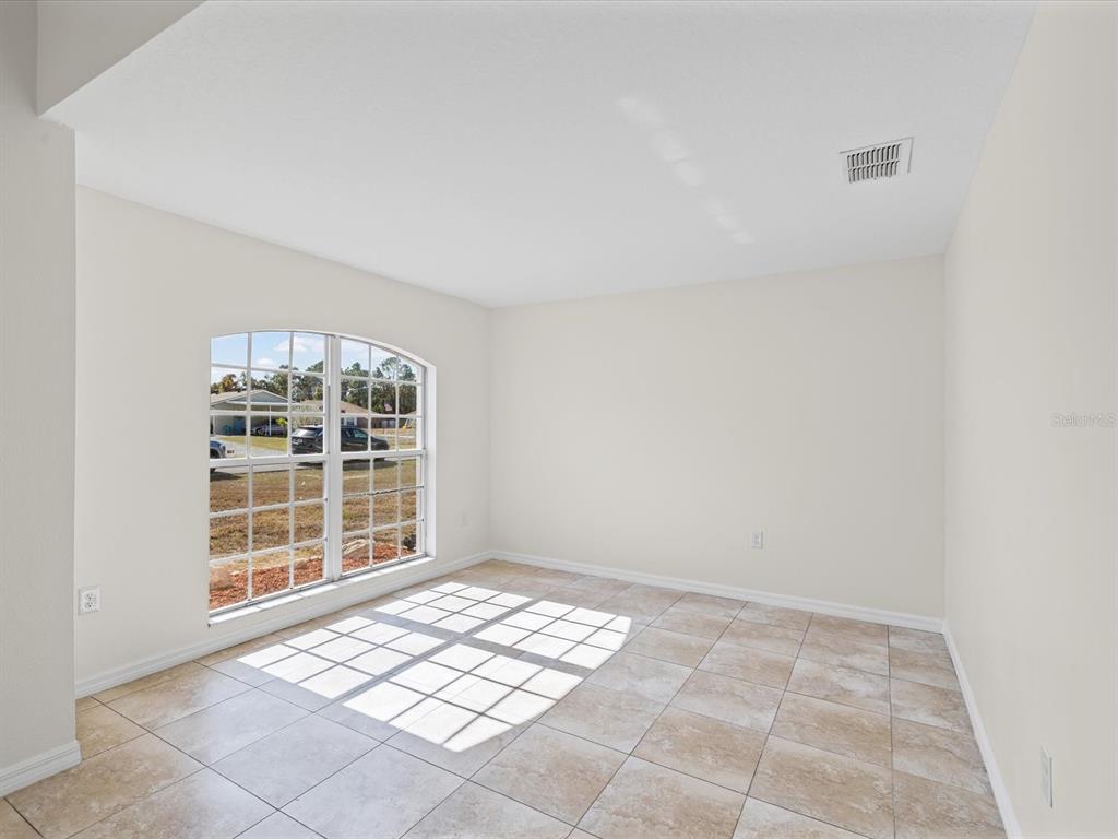 11217 Kangley Lane Spring Hill, FL 34608 - Photo 10 of 43 an empty room with windows