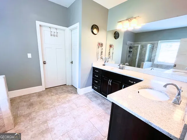 a large bathroom with a sink vanity and a mirror