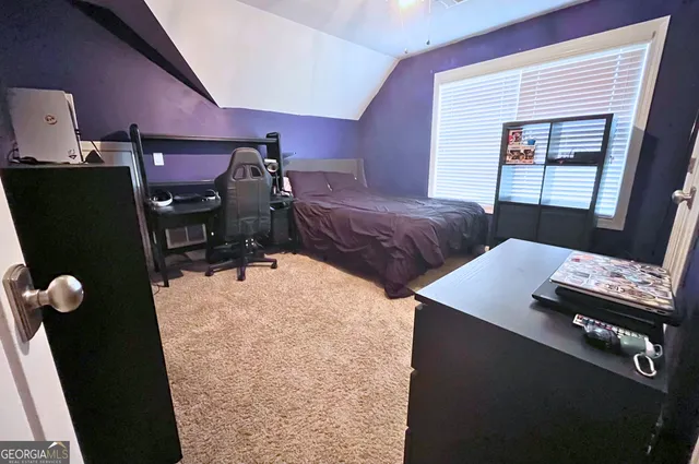 a bedroom with furniture and window