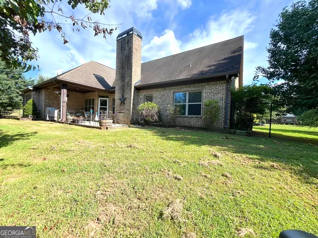a front view of a house with a yard table and chairs