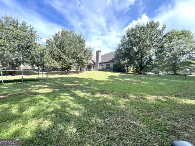 a swimming pool with trees in the background