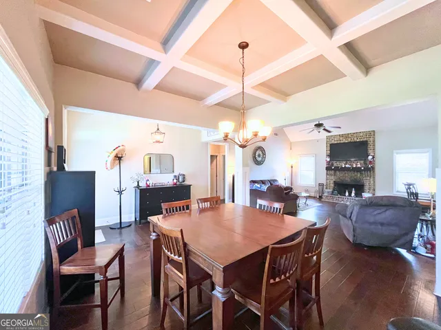 a view of a dining room with furniture and a chandelier